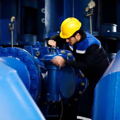 Worker checking the oil pipeline equipment